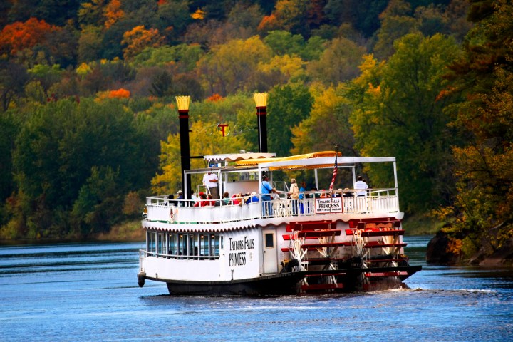 a boat traveling along a river next to a body of water